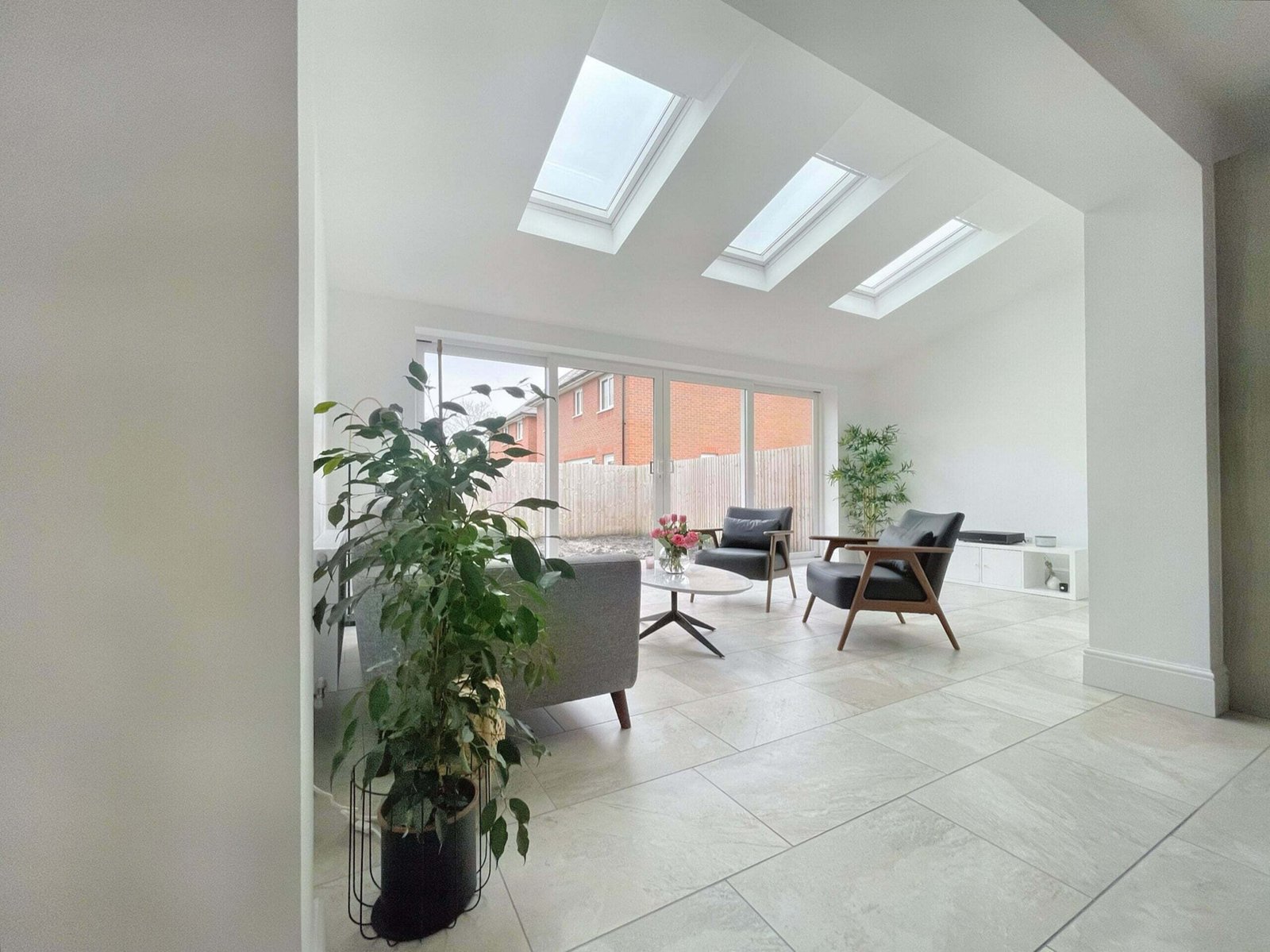 Modern open plan living room extension featuring bright skylights by Liverpool builders Glassar Projects